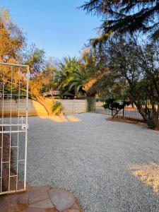 a gate in a parking lot with a fence at Rainbow Palace in Bloemfontein +42 photos
