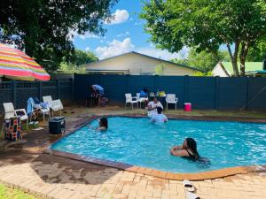 a group of people in a swimming pool at Rainbow Palace in Bloemfontein