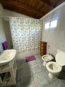 a bathroom with two toilets and a sink and a shower at Evergreen in Mar del Plata +14 photos