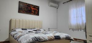 a bedroom with a bed with a quilt on it at Villa Star in Tirana
