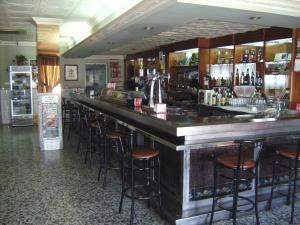 a bar in a restaurant with bar stools at Hostal El Polígono in Lucena +38 photos
