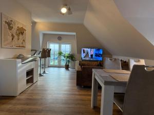 a living room with a couch and a table at Ferienwohnung Bernsteinsucher städtische Bestlage in Ribnitz-Damgarten
