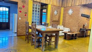 a dining room with a wooden table and chairs at Pousada Portal do Céu in Visconde De Maua +70 photos