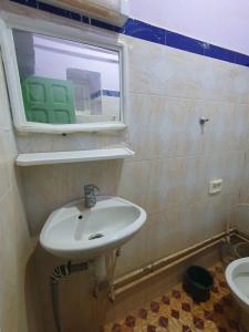 a bathroom with a sink and a window at Auberge camping la tradition in Merzouga +79 photos