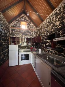 a stone kitchen with a sink and a stove at Casa Duque in Santana with AC and heating in Santana