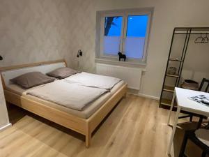 a bedroom with a bed and a desk and a window at Ferienwohnung Heike Heitmann - Maisonette-Wohnung oder Apartment in Eystrup