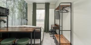 una camera da letto con una scrivania e un letto con una finestra di Praga Studio Apartments a Varsavia Altre 25 foto