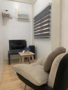a living room with a couch and a table at Mountain View Anilao in Mabini