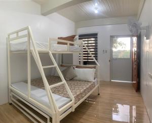 a room with two bunk beds and a hallway at Mountain View Anilao in Mabini