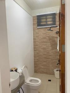 a bathroom with a toilet and a sink at Mountain View Anilao in Mabini