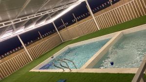 a large swimming pool in an empty stadium at Alharamil Retreat in Ras al Khaimah