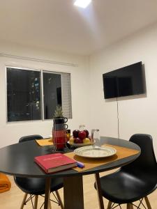 a dining room table with a bowl of fruit on it at Apartamento Loft in Balneário Camboriú