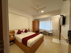 a hotel room with a bed and a television at Zipp Lite - HAL Old Airport Road in Bangalore +16 photos