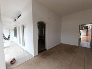 an empty room with white walls and a tile floor at Casa Duque Peruíbe in Peruíbe +16 photos