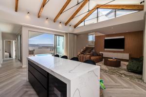 a kitchen and living room with a view of a living room at Pinnacle Villa in Plettenberg Bay