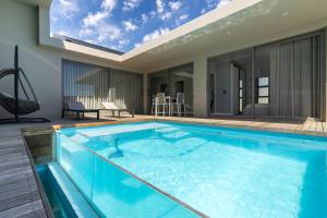 a swimming pool in the middle of a house at Pinnacle Villa in Plettenberg Bay