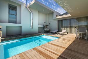 a house with a swimming pool in a room at Pinnacle Villa in Plettenberg Bay