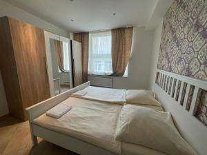 a bedroom with a white bed in a room at City Lux Hannover in Hannover