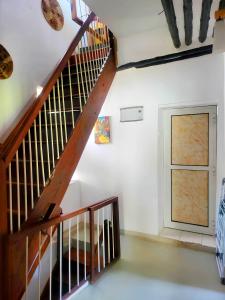 a wooden staircase in a room with a door at Seafarers Loft in Stone Town +13 photos