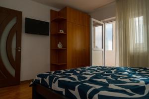 a bedroom with a bed and a sliding glass door at House Dey in Făgăraş