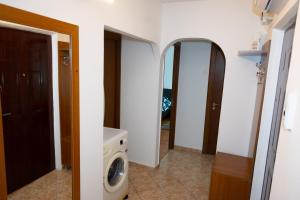 a laundry room with a washing machine and a mirror at House Dey in Făgăraş