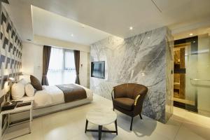 a bedroom with a bed and a desk and a chair at Hotel Soulhada Gangnam in Seoul