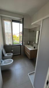a bathroom with a sink and a toilet and a sink at Brianza Verde 25 in Bernareggio +16 photos