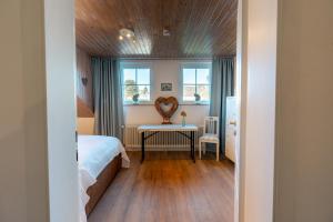 a bedroom with a bed and a table in a room at Chalet Flandesbach in Velbert