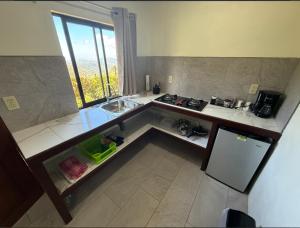 a kitchen with a sink and a counter top at Sunset Farms and Waterfalls! in Tilarán