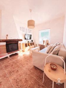 a living room with a couch and a fireplace at Maty's Place in Mafra