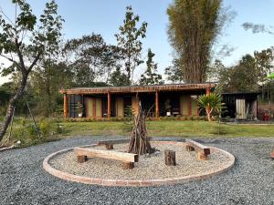 a house with a bench in front of it at Mae on country home in Ban On Luai