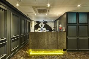 a lobby with a bar with a painting of a cow at Hotel Soulhada Gangnam in Seoul