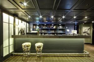 a bar with two chairs in front of a counter at Hotel Soulhada Gangnam in Seoul