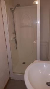 a shower in a bathroom next to a white sink at LA Chataigne in Santranges +5 photos