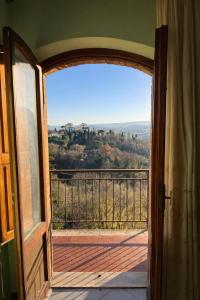 an open door to a balcony with a view at Vita Toscana Guest House in Chiusi