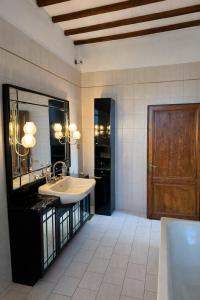 a bathroom with a sink and a wooden door at Vita Toscana Guest House in Chiusi