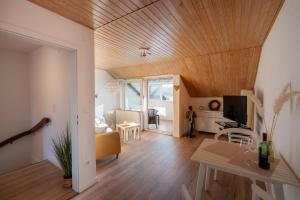 a living room with a wooden ceiling at Chalet Flandesbach in Velbert