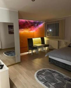 a bedroom with a bed and a desk in a room at Olimpic Apartmani BG in Batajnica