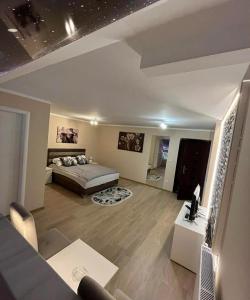 a living room with a bed and a couch at Olimpic Apartmani BG in Batajnica +5 photos