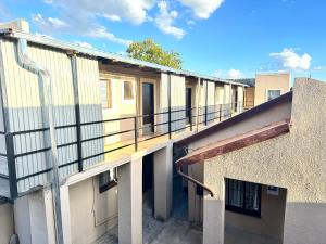an outside view of a building with a balcony at SleepCozyGuestHouse in Soweto