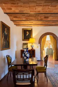 a dining room with a table with a vase on it at Vita Toscana in Chiusi +1 photo