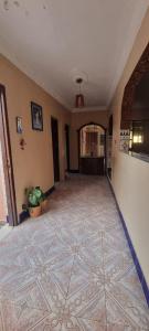 an empty hallway with a tile floor in a house at Horizon heights in El Haouma
