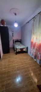 a room with a bed in the corner of a room at Horizon heights in El Haouma +1 photo