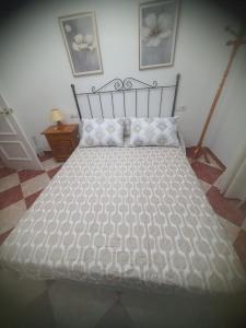 a bedroom with a bed with a white comforter at La Torre in Tózar