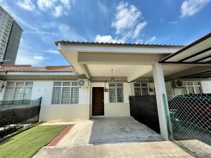 a house with a gate in front of it at DOUBLETHREE Seroja Sepang in Sepang