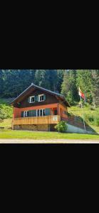 a large house with a flag in front of it at Auszeithütte in Flattnitz