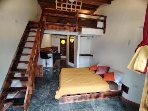 a bedroom with a bunk bed and a staircase at Alma de cedrela in Puerto Ayora