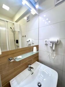 een badkamer met een wastafel en een spiegel bij Hotel Astra in Praag