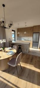 een keuken met een tafel en stoelen en een aanrecht bij Eko Osada Zacisze in Ostrowite