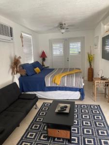 a bedroom with a bed and a couch at Stunning suite by hard rock stadium and casino in Miami